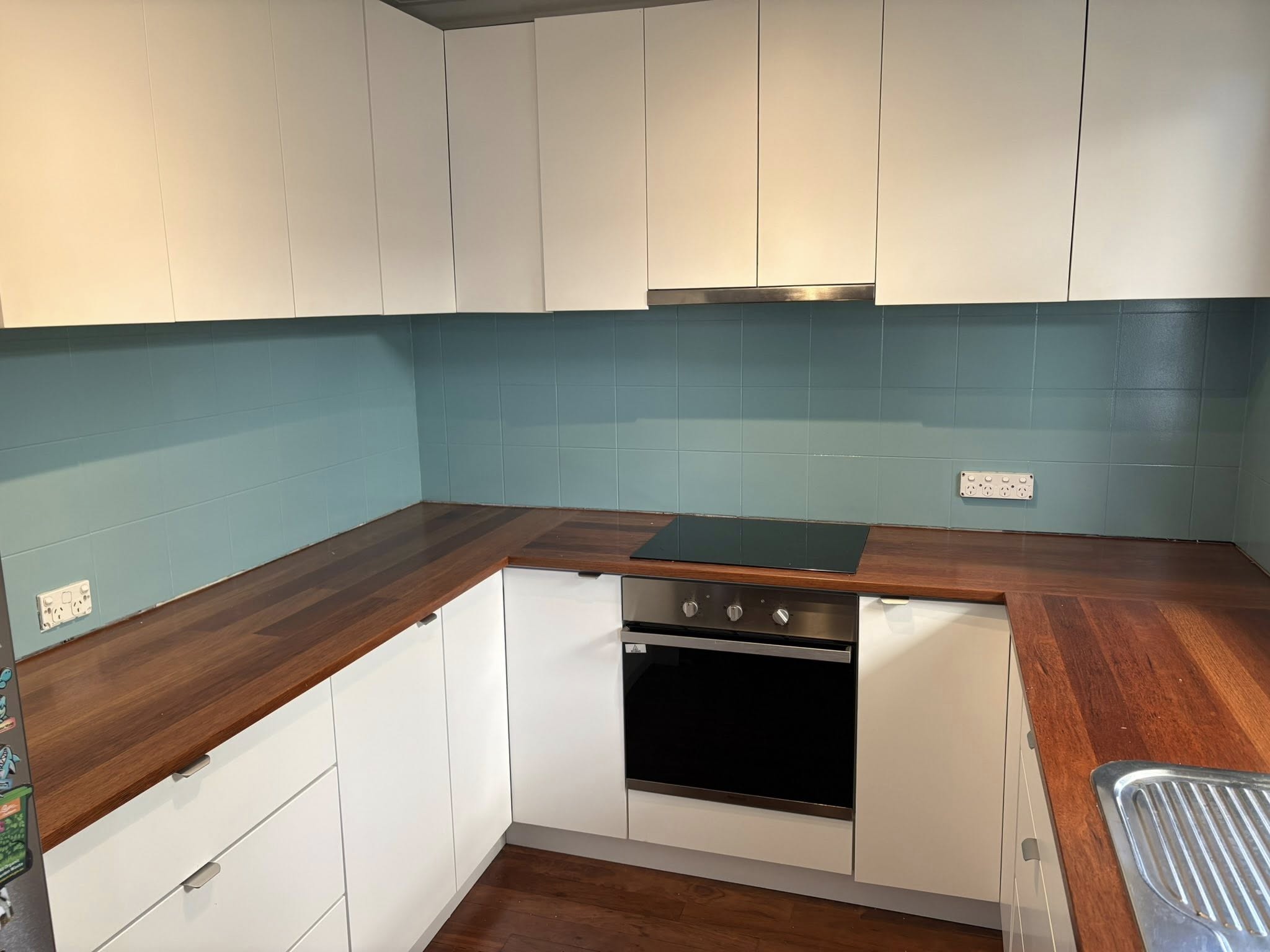 Kitchen tiles repainted in soft blue-green