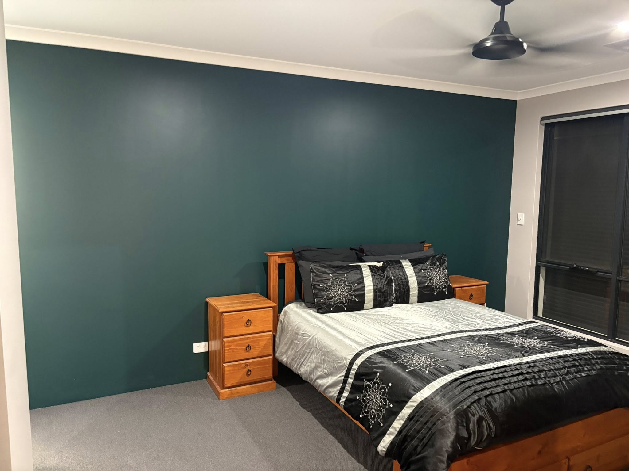 Master bedroom with deep green feature wall